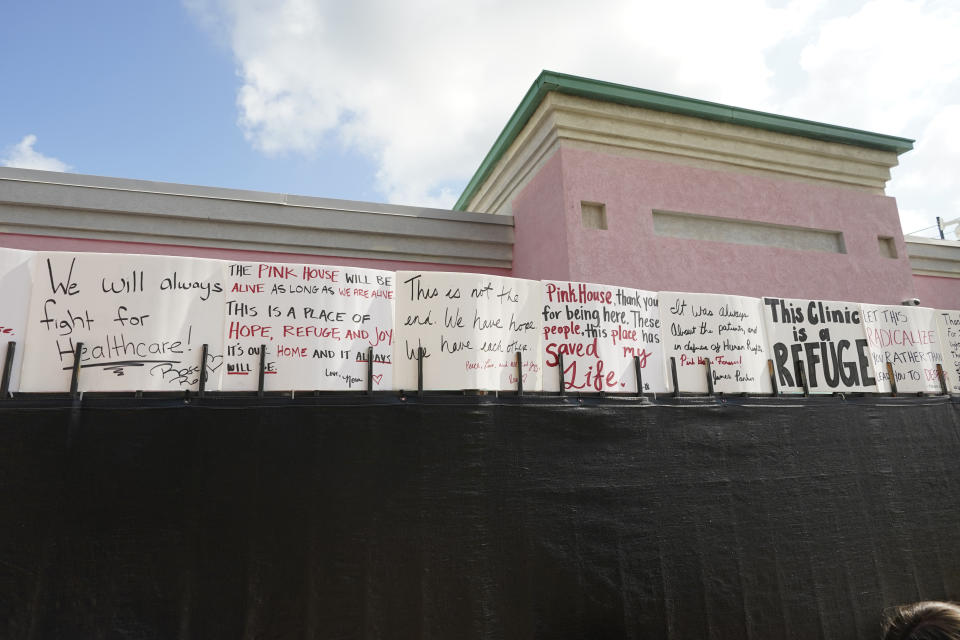 Abortion rights advocates posted supportive signs on the privacy fencing outside the Jackson Women's Health Organization clinic in Jackson, Miss., Thursday, July 7, 2022. The clinic was the only facility that performed abortions in the state. However, on Tuesday, a chancery judge rejected a request by the clinic to temporarily block a state law banning most abortions. Without other developments in the Mississippi lawsuit, the clinic ceased abortions the end of business Wednesday and the state law took effect Thursday. The clinic saw a limited number of patients on Thursday, but not for abortions. (AP Photo/Rogelio V. Solis)