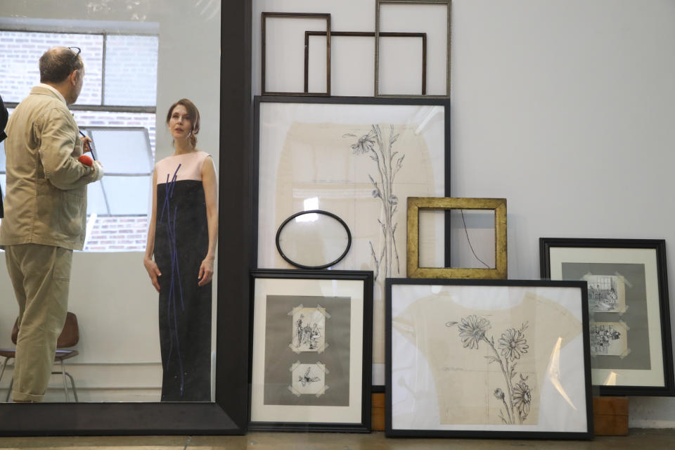 In this Sept. 4, 2019, photo, designer Herve Pierre, left, fits Emmy-nominated actress Jessica Hecht with a dress for her to wear at the Creative Arts Emmy Awards, at Atelier Caito for Herve Pierre in New York. (AP Photo/Mary Altaffer)