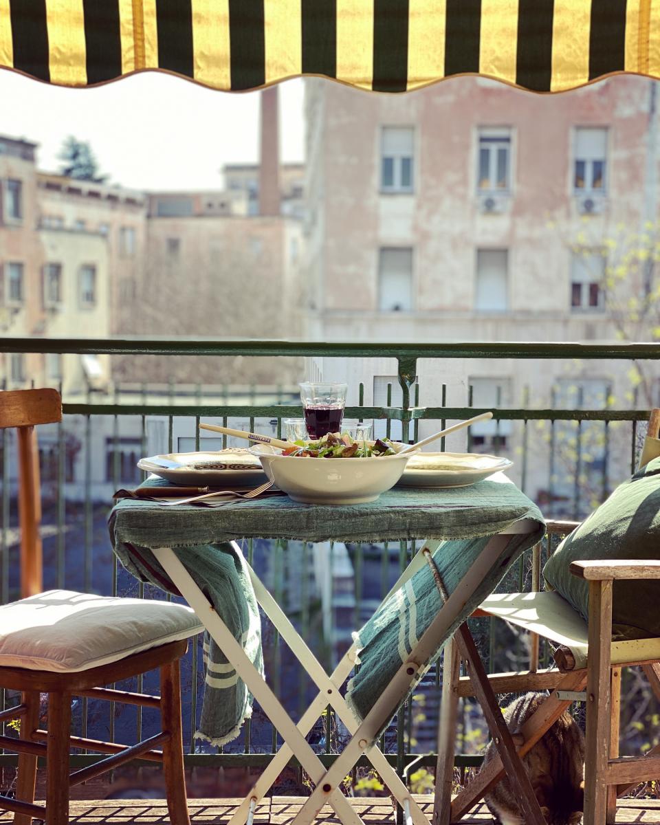 Andrea Ferolla and Daria Reina set up a table on the terrace of their apartment in Rome.