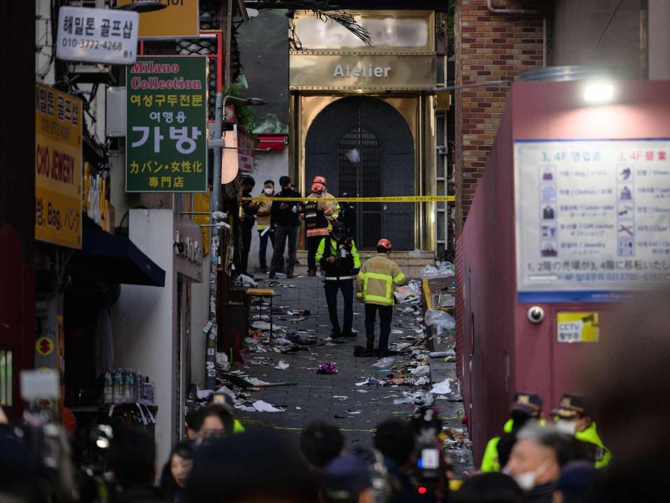 Emergency service personnel are seen in a cordoned off alley in the Itaewon district where a Halloween stampede took place, on October 30, 2022.