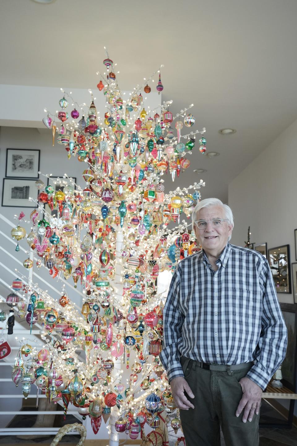 Kevin Milaeger stands next to the showcase Christmas tree he decorated in his home in Caledonia on Dec. 4, 2023. His wife, Susan, not pictured, arranges the other Christmas collections in their home.