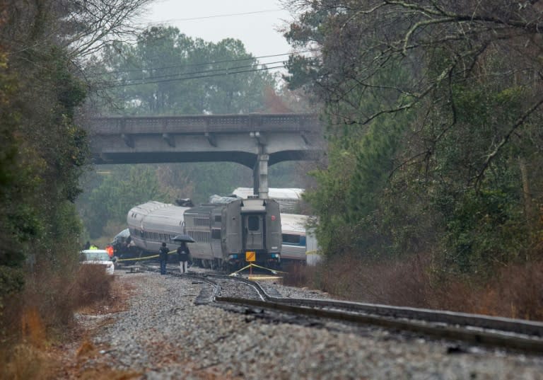 A derailed Amtrak car seen up the tracks near a crossing after an early morning collision with a CSX freight train in Cayce, South Carolina