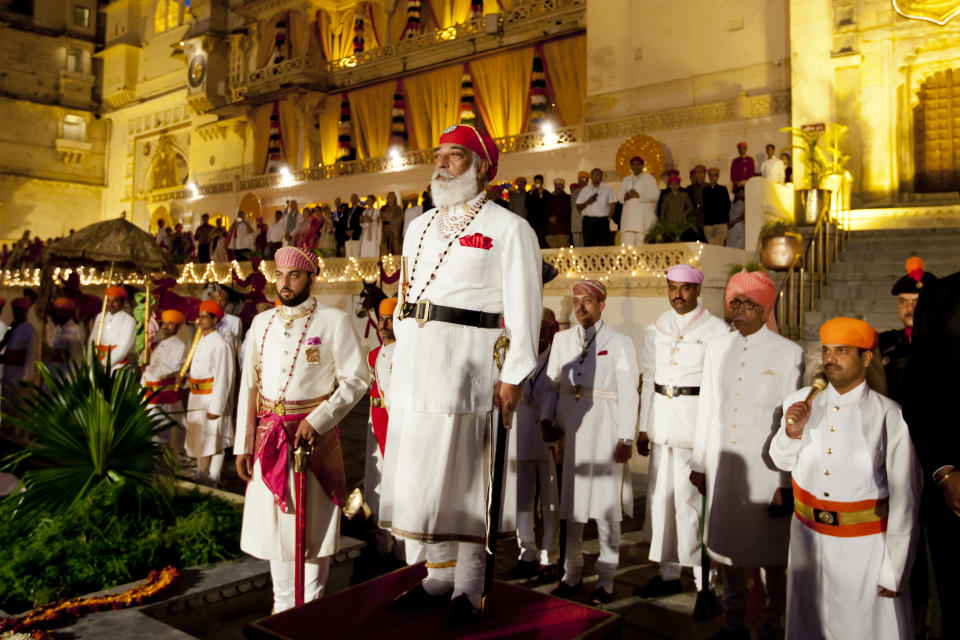 INDIA - MARCH 19:  Shriji Arvind Singh Mewar of Udaipur, 76th Custodian of the House of Mewar, presides at annual Hindu Holi Fire Festival at The Zenana Mahal in the City Palace, Udaipur, Rajasthan, India. On his right is son Lakshyaraj Singh Mewar of Udaipur, Maharaj Kumar.

  (Photo by Tim Graham/Getty Images)