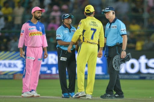 Dhoni (number 7) confronts the umpires after running onot the field