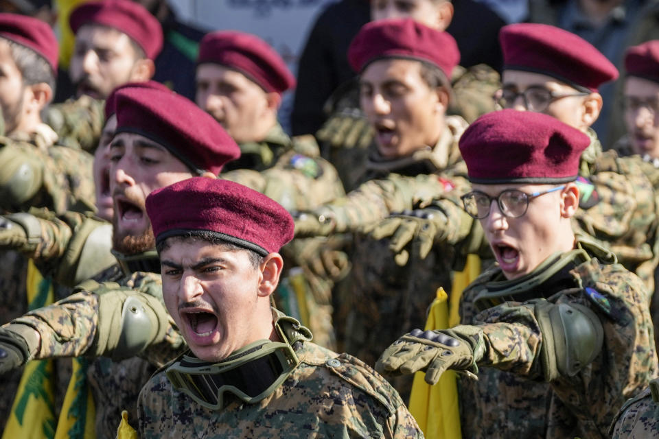 Hezbollah fighters chant slogans as they attend the funeral procession of senior Hezbollah commander Wissam Tawil, during his funeral procession in the village of Khirbet Selm, south Lebanon, Tuesday, Jan. 9, 2024. The elite Hezbollah commander who was killed in an Israeli airstrike Monday in southern Lebanon fought for the group for decades and took part in some of its biggest battles. (AP Photo/Hussein Malla)