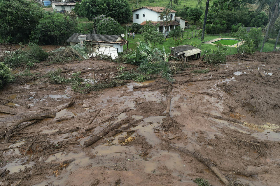 An aerial view shows a partially destroyed house after a dam collapsed in Brumadinho, Brazil, Saturday, Jan. 26, 2019. An estimated 300 people were still missing and authorities expected the death toll to rise during a search made more challenging by intermittent rains. (AP Photo/Andre Penner)