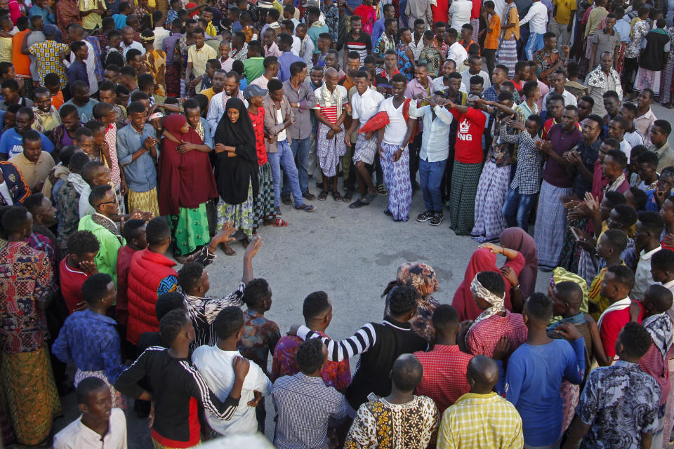 Somalis engage in a traditional dance in a street in Mogadishu, Somalia Friday, Jan. 29, 2021. As Somalia marks three decades since a dictator fell and chaos engulfed the country, the government is set to hold a troubled national election but two regional states are refusing to take part in the vote to elect Somalia's president and time is running out before the Feb. 8 date on which mandates expire. (AP Photo/Farah Abdi Warsameh)