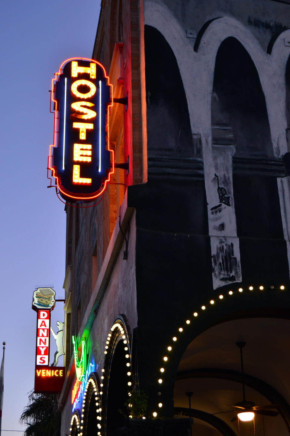 A hostel sign lit up.