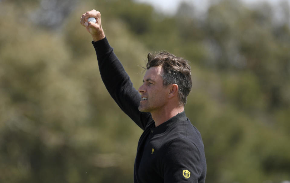 International team player Adam Scott of Australia celebrates a win over the U.S. during their fourball match at the Royal Melbourne Golf Club in the opening rounds of the President's Cup golf tournament in Melbourne, Thursday, Dec. 12, 2019. (AP Photo/Andy Brownbill)