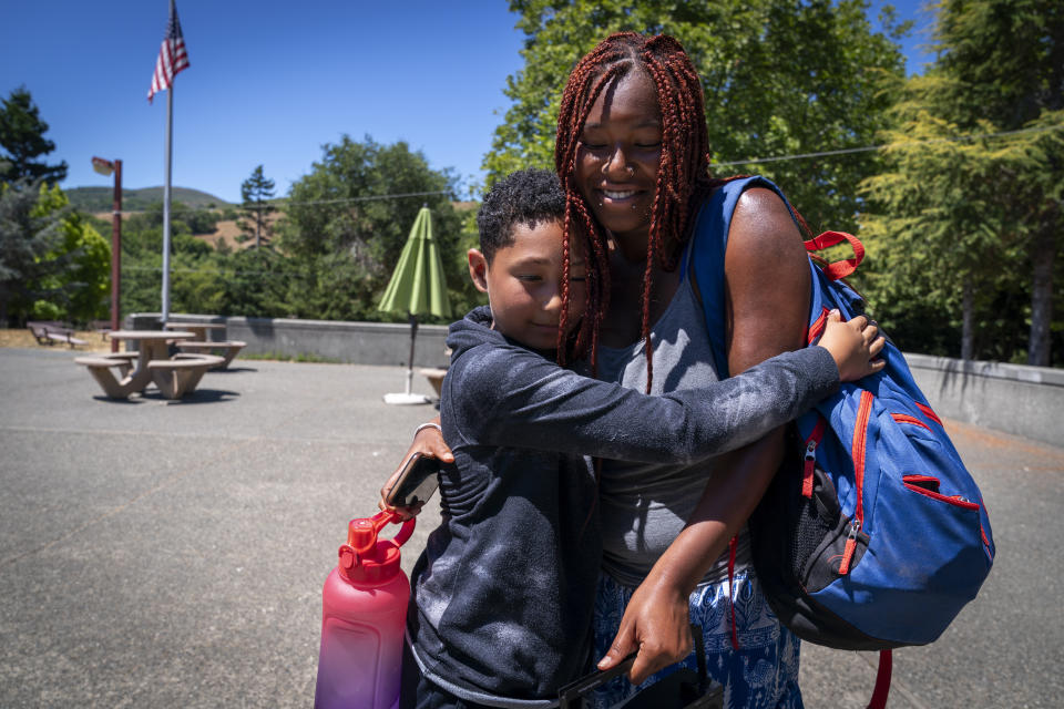 Isaac Harrison, 10, of Oakland, Calif., hugs counselor Satya Sheftel-Gomes, 22, of San Francisco, as he prepares to leave Camp Be’chol Lashon, a sleepaway camp for Jewish children of color, Saturday, July 29, 2023, in Petaluma, Calif., after his first experience at Walker Creek Ranch, his first experience at the camp held at Walker Creek Ranch. He went to a traditional Jewish summer camp last year and said he was bullied by some campers for being Black. “They were just being really mean, but here no one’s mean like that,” said Harrison. (AP Photo/Jacquelyn Martin)