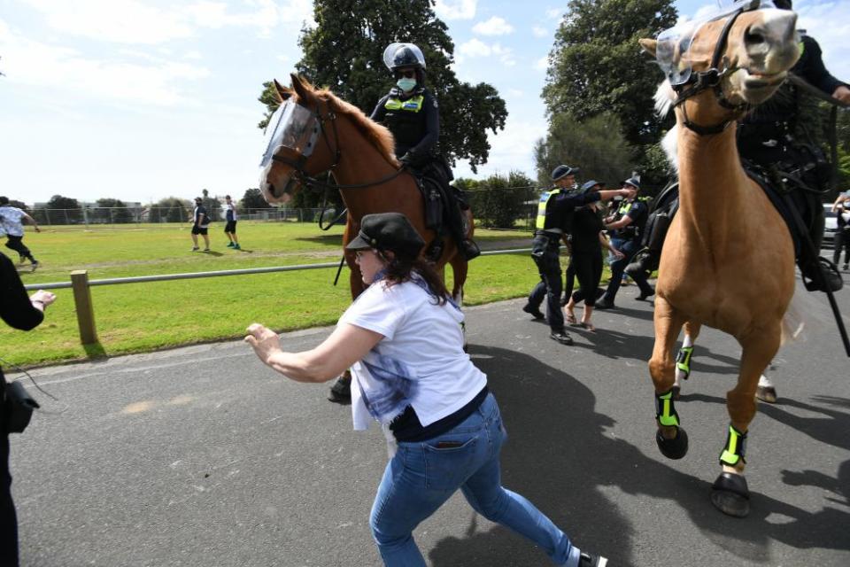 Police try to intercept demonstrators during the anti-lockdown protest