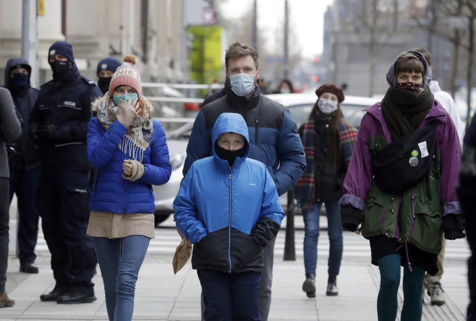 FILE - In this Saturday, March 20, 2021 file photo, few people walk on the streets after Poland reintroduced a partial nationwide lockdown on Saturday to curb a sudden spike in new COVID-19 cases, in Warsaw, Poland. Many regions in Central Europe and the Balkans are facing one of the most difficult moments since the coronavirus pandemic struck over a year ago. Poland recorded its highest daily number of new coronavirus infections Wednesday March 24, 2021, as hospitals buckled under a new surge. (AP Photo/Czarek Sokolowski, File)