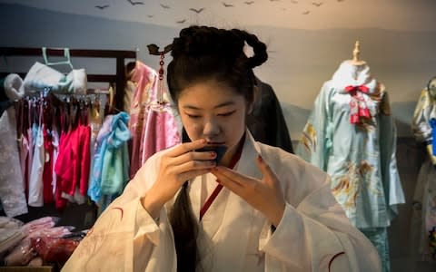 Chi Yunuo, owner of a Hanfu shop, drinks tea in her shop - Credit: Giulia Marchi for The Telegraph