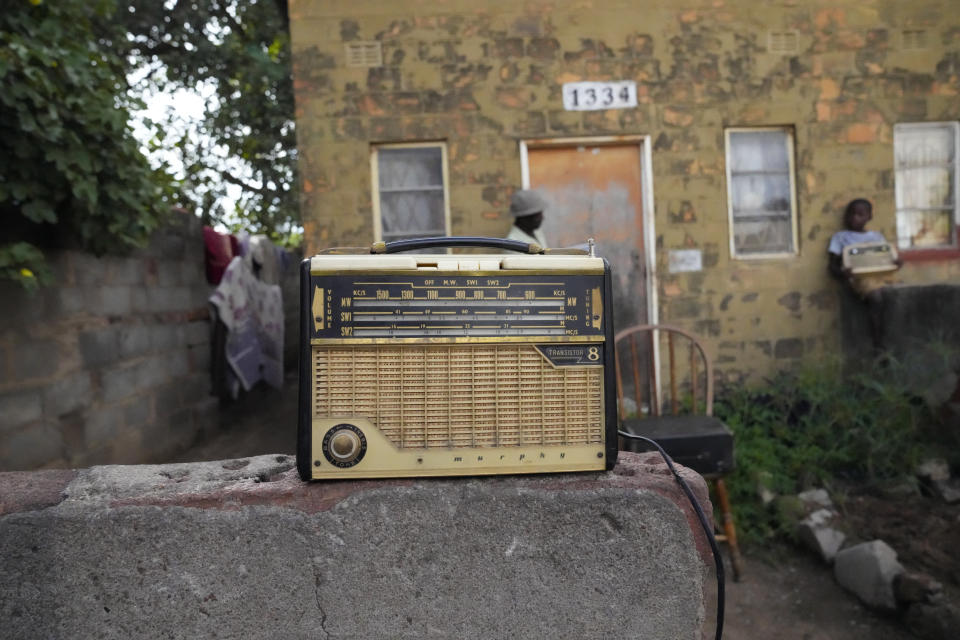 An old radio is placed outside Ngwiza Khumbulani Moyo's home in Bulawayo, Wednesday, Feb. 15, 2023. In many Western countries, conventional radio has been overtaken by streaming, podcasts and on-demand content accessed via smartphones and computers. But in Zimbabwe and much of Africa, traditional radio sets and broadcasts are widely used, highlighting the digital divide between rich countries and those where populations struggle to have reliable internet. (AP Photo/Tsvangirayi Mukwazhi)