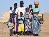 Zakaria Sawadogo poses for a photograph with family members in Kamboinse, a northern district of Ouagadougou, Burkina Faso