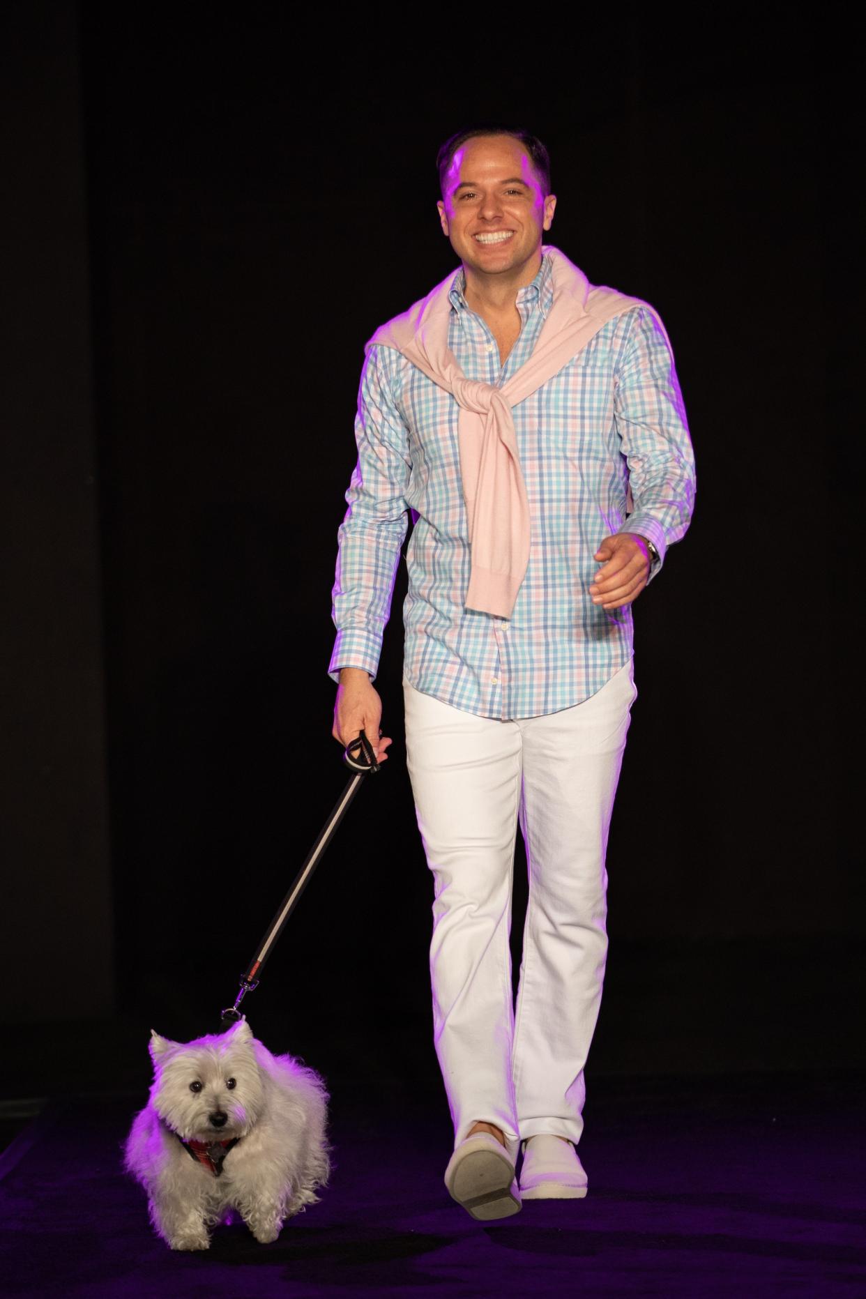 Paul Clowers of The Development Department showed off his million-dollar smile with Georgia at the Men of the Desert fashion show on Dec. 8, 2019.