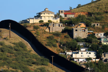 Buildings in Nogales, Mexico (R) are separated by a border fence from Nogales, Arizona, United Sates, October 9, 2016. REUTERS/Mike Blake