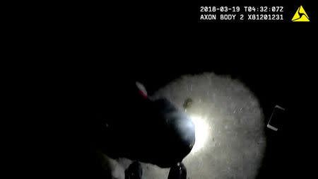 An iPhone is visible next to a man shot by police officers in this still image captured from police bodycam video footage released by Sacramento Police Department, California, U.S., on March 21, 2018. Courtesy Sacramento Police Department/Handout via REUTERS .