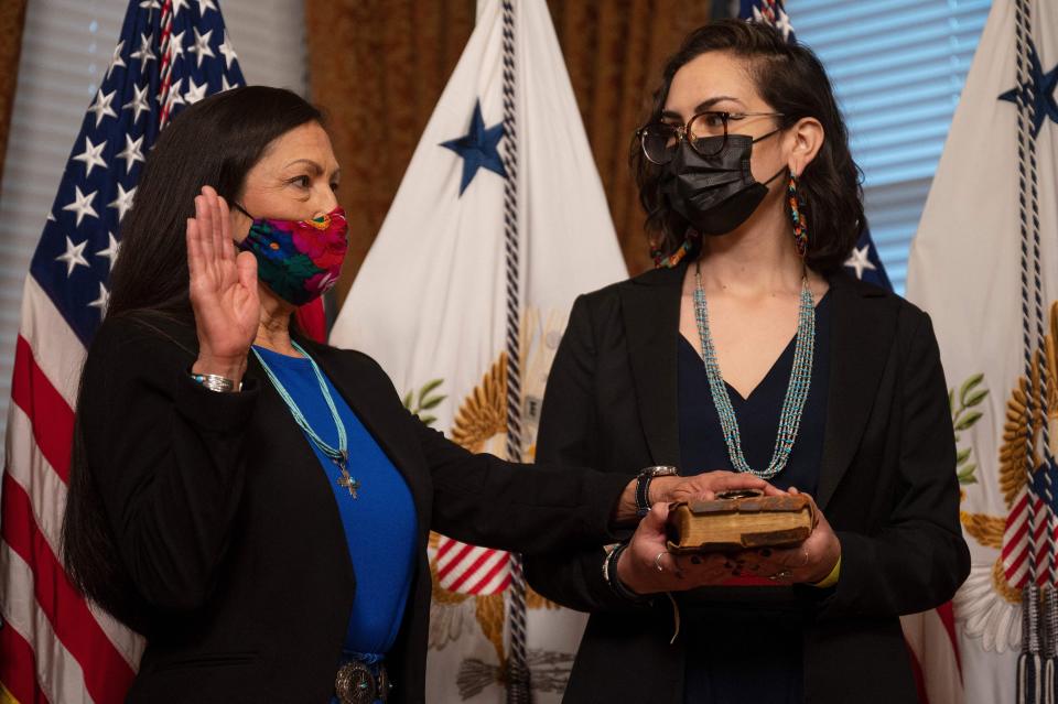 Interior Secretary Deb Haaland is sworn in as her daughter, Som&aacute;h Haaland, holds the Bible on March 18, 2021.  (Photo: JIM WATSON via Getty Images)