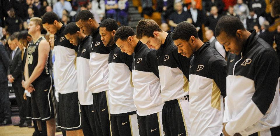 Members of the Purdue mens basketball team pause for a moment of silence before their NCAA college basketball game against Northwestern in Evanston, Ill., on Tuesday, Jan. 21, 2014. Their was shooting on their campus earlier in the day. (AP Photo/Matt Marton)