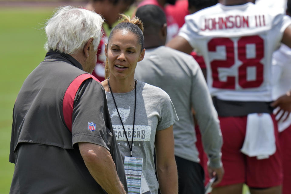 Candice Davis-Price, right, performance coach at Belleville High School in Michigan, talks to Tom Moore, Tampa Bay Buccaneers senior offensive assistant, at the NFL football team's rookie training camp. Friday, May 10, 2024, in Tampa, Fla. Twenty-five aspiring NFL coaches, with wide-ranging backgrounds, joined together at the inaugural Tampa Bay Buccaneers National Coaching Academy. (AP Photo/Chris O'Meara)