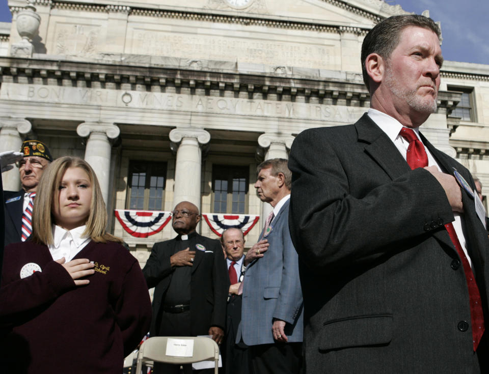 <p>Participants place their hands on their hearts during the playing of the national anthem at a Veterans Day ceremony in front of the Delaware County Courthouse in Media, Pa., Nov. 11, 2004. (Photo: Jacqueline Larma/AP) </p>