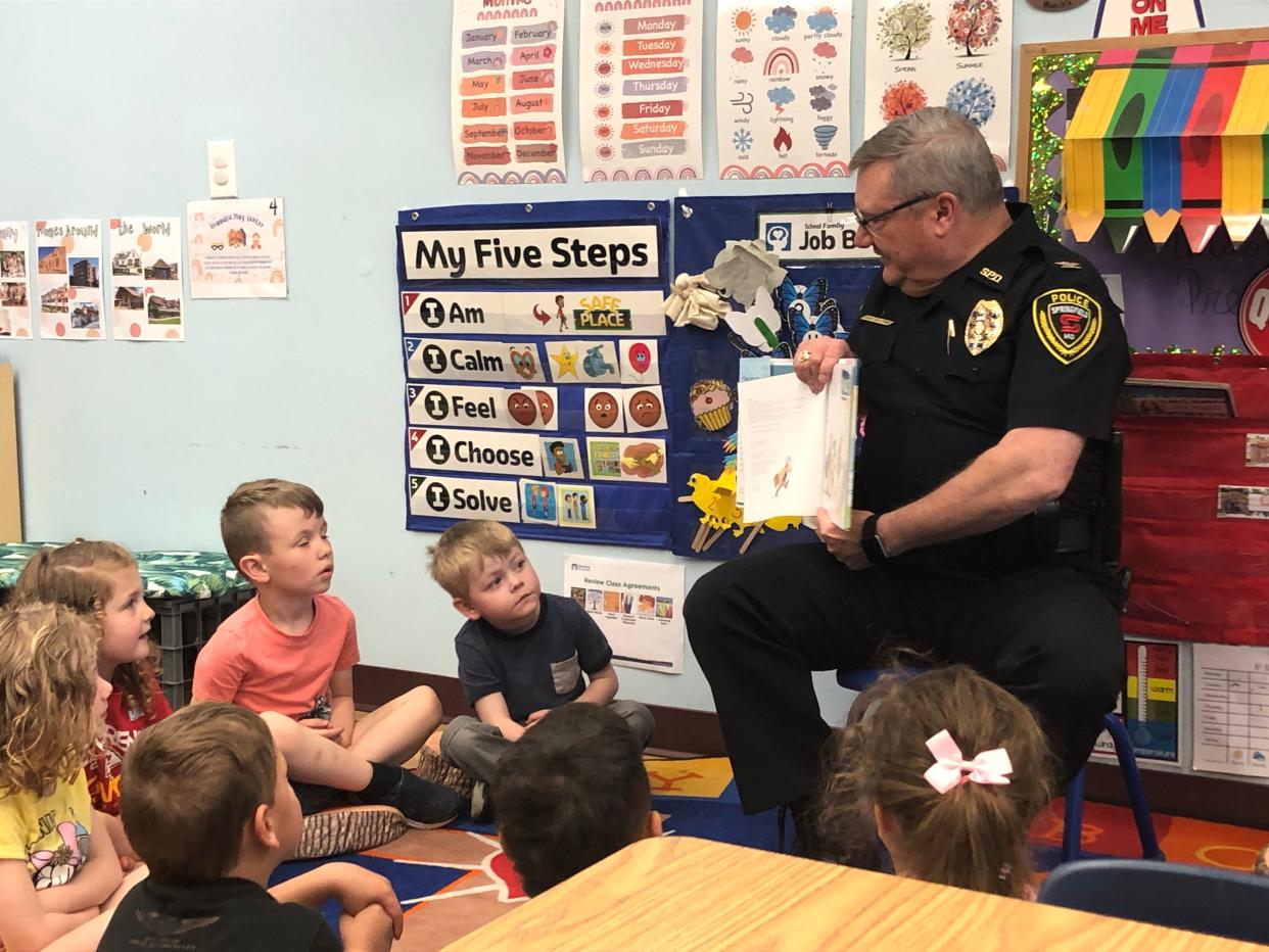 Springfield Chief of Police Paul Williams reads "Police Officers on Patrol" to the preschool class the morning of Friday, April 14, 2023, at Messiah Lighthouse Child and Family Development Center. Williams was one of three speakers who urged Missouri's legislature to approve increases in funding for early childhood education and family and provider subsidies.