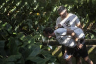 Visitors walk in the garden during a guided tour of Roberto Burle Marx’s former home, which was elected today as a World Heritage Site by the United Nations Educational, Scientific and Cultural Organization, UNESCO, in Rio de Janeiro, Brazil, Tuesday, July 27, 2021. The site features more than 3,500 species of plants native to Rio and is considered a laboratory for botanical and landscape experimentation. (AP Photo/Bruna Prado)