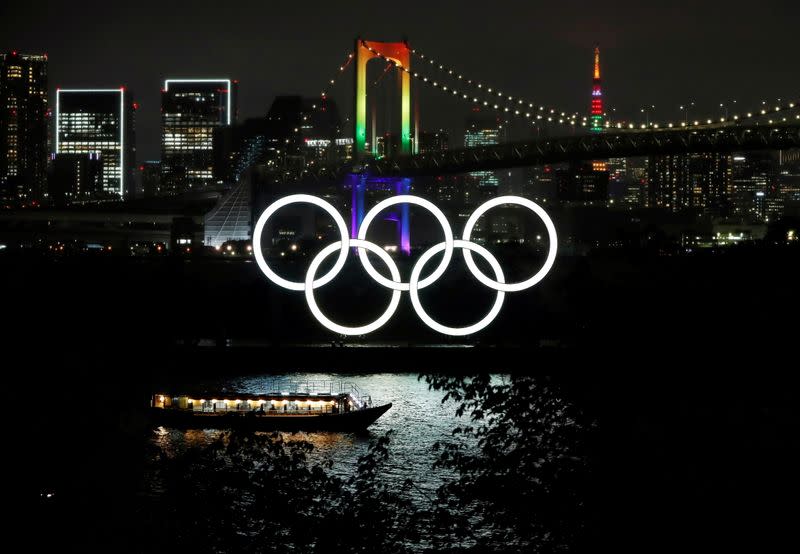 The Rainbow Bridge and Tokyo Tower are illuminated with Olympic colours to mark 100 days countdown to the Tokyo 2020 Olympics in Tokyo