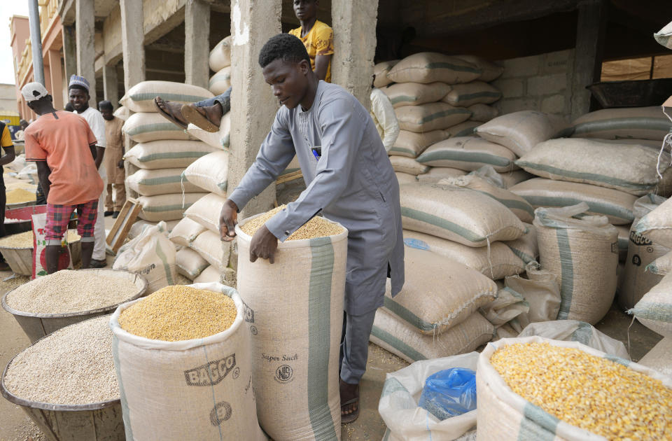 A man sells grain in Dawanau International Market in Kano Nigeria, Friday, July 14, 2023. Nigeria introduced programs before and during Russia's war in Ukraine to make Africa's largest economy self-reliant in wheat production. But climate fallout and insecurity in the northern part of the country where grains are largely grown has hindered the effort. (AP Photo/Sunday Alamba)