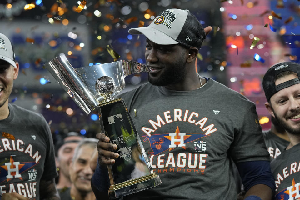 Houston Astros designated hitter Yordan Alvarez holds the trophy after their win against the Boston Red Sox in Game 6 of baseball's American League Championship Series Friday, Oct. 22, 2021, in Houston. The Astros won 5-0, to win the ALCS series in game six. (AP Photo/David J. Phillip)