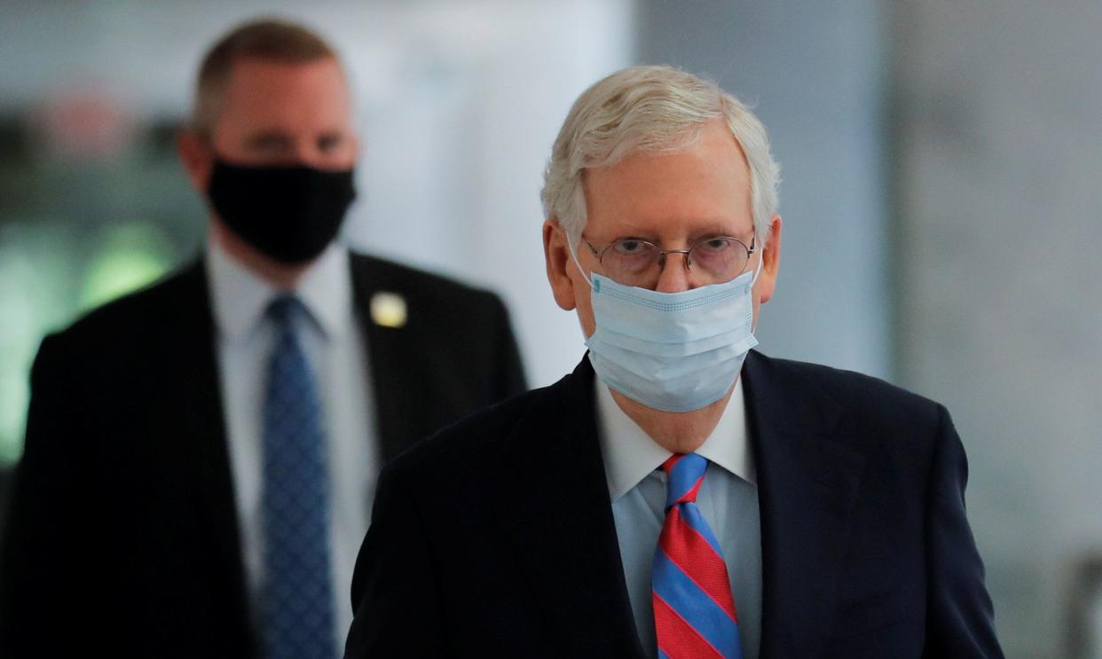 Senate Majority Leader Mitch McConnell (R-Ky.) wears a protective face mask as he walks down a hallway of the Hart Senate Office Building in Washington, May 12, 2020.  (Photo: Carlos Barria / Reuters)