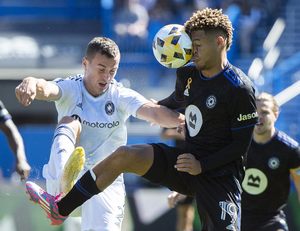 CF Montreal's Zorhan Bassong, right, challenges Chicago Fire FC's Boris Sekulic during first half MLS soccer action in Montreal, Sunday, Sept. 19, 2021. (Graham Hughes/The Canadian Press via AP)