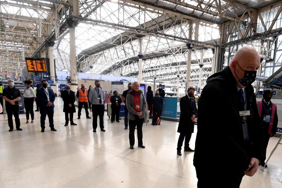 People pause to observe two minutes' silence at Waterloo Station, as part of Armistice Day remembrance commemoration, in London, Britain November 11, 2020. REUTERS/Dylan Martinez