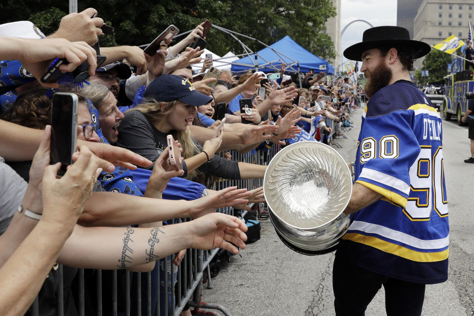 St. Louis Blues center Ryan O'Reilly carries the Stanley Cup during the Blues' NHL hockey Stanley Cup victory celebration in St. Louis on Saturday, June 15, 2019. (AP Photo/Darron Cummings)