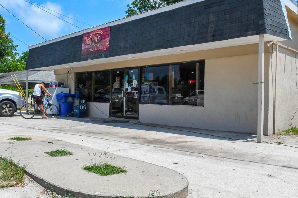 Grass grows where gasoline pumps once rose from the concrete pad as a customer parks their bicycle near the front entrance to Chaplin’s Grocery as photographed on Wednesday, June 26, 2024 on St. Helena Island. Built by Howard Chaplin, this year will mark 50 years the family-owned store has been in operation.