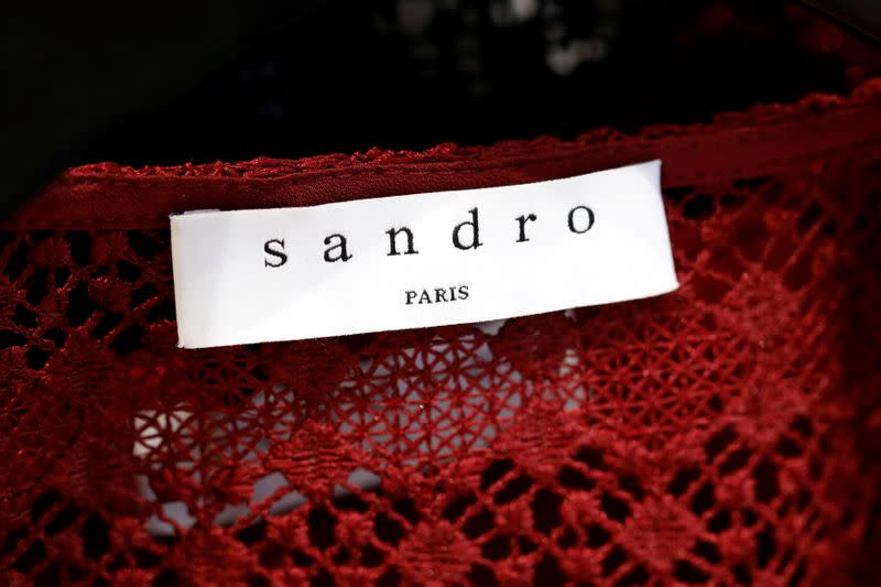 FILE PHOTO: A Sandro label is pictured on clothes inside a Sandro luxury clothing store, operated by SMCP Group, in Paris