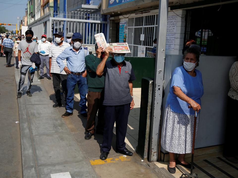 FILE PHOTO: People wait outside Lima's central market as Peru extended a nationwide lockdown amid the outbreak of the coronavirus disease (COVID-19), in Lima, Peru May 8, 2020. REUTERS/Sebastian Castaneda 