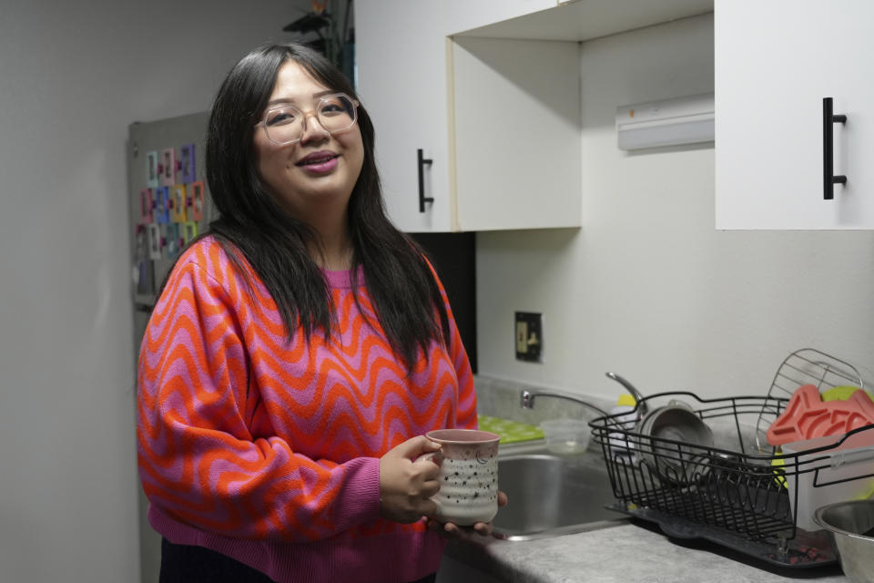 Celina Chanthanouvong poses in her apartment in Emeryville, Calif., on June 2, 2023. After a payment pause that has lasted more than three years, more than 40 million student loan borrowers will be on the hook for payments starting in late August. The pause in repayment has been a lifeline keeping 25-year-old Chanthanouvong afloat. (AP Photo/Terry Chea)