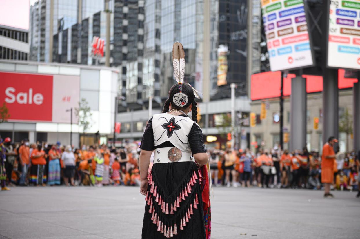 <span class="caption">A young dancer looks on before performing for a crowd during a 'Cancel Canada Day' rally in Toronto, in 2021.</span> <span class="attribution"><span class="source">THE CANADIAN PRESS/Christopher Katsarov</span></span>