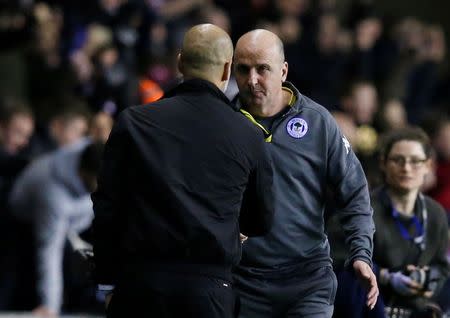 Soccer Football - FA Cup Fifth Round - Wigan Athletic vs Manchester City - DW Stadium, Wigan, Britain - February 19, 2018 Wigan Athletic manager Paul Cook shakes hands with Manchester City manager Pep Guardiola after the match REUTERS/Andrew Yates