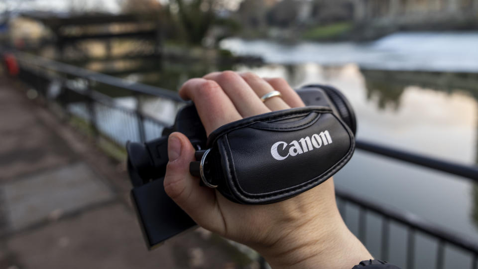 The Canon HF G70 being handheld using the strap