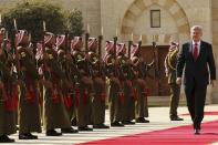 Canada's Prime Minister Stephen Harper review Bedouin honour guards during Harper's visit to Jordan at the Royal Palace in Amman January 23, 2014. REUTERS/Muhammad Hamed (JORDAN - Tags: POLITICS MILITARY)