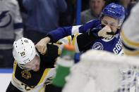Tampa Bay Lightning center Yanni Gourde (37) and Boston Bruins center Joakim Nordstrom (20) exchange punches during a fight during the second period of an NHL hockey game Tuesday, March 3, 2020, in Tampa, Fla. (AP Photo/Chris O'Meara)