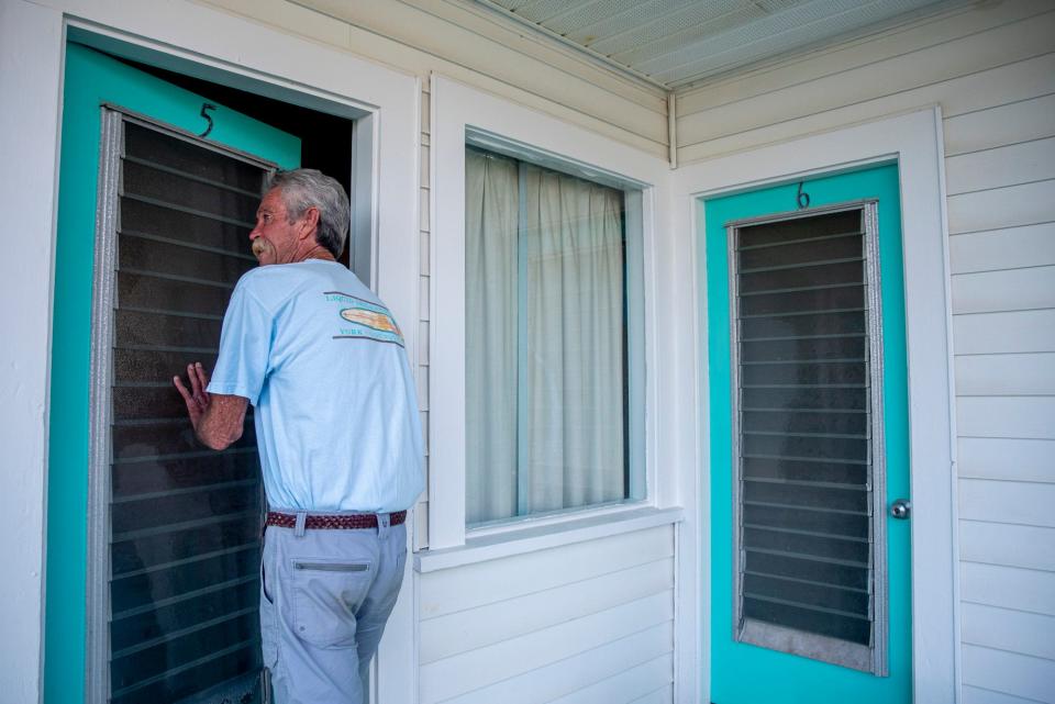 Paul de la Pena, 65, owner of the Nevada Motel, enters Room 5 of the motel in York, Maine, on July 28, 2021.