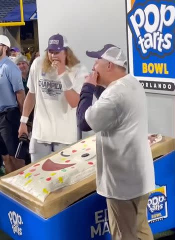 <p>Poptarts Bowl/ Instagram</p> Kansas State quarterback Avery Johnson and head coach Chris Klieman eating the "edible mascot' at Pop-Tarts Bowl on December 28, 2023