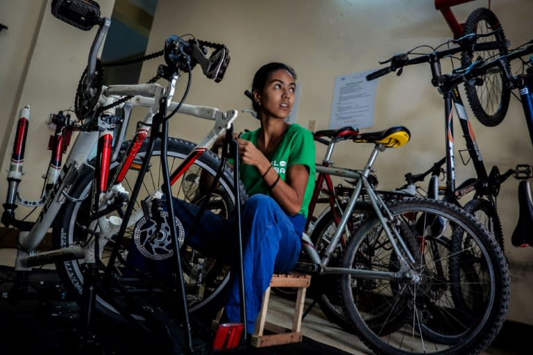 A woman fixes a bike at the VeloCuba bicycle repair and rental agency in Havana