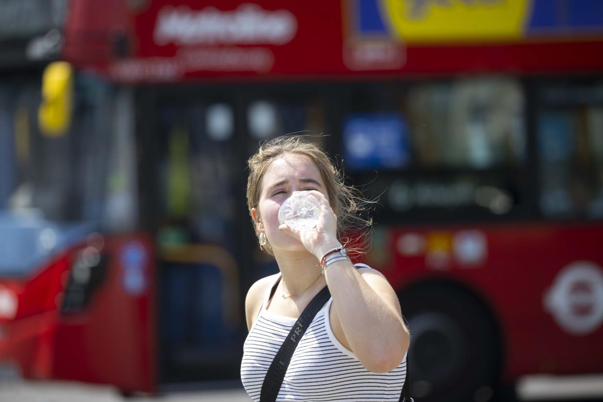 LONDON, UNITED KINGDOM - JULY 19: A women drinks water to cool off as heatwave hits London, United Kingdom on July 19, 2022. The UK Meteorological Service (Met Office) issued an extreme temperature warning that temperatures could reach 39 degrees Celsius, posing a serious risk on health. (Photo by Rasid Necati Aslim/Anadolu Agency via Getty Images)