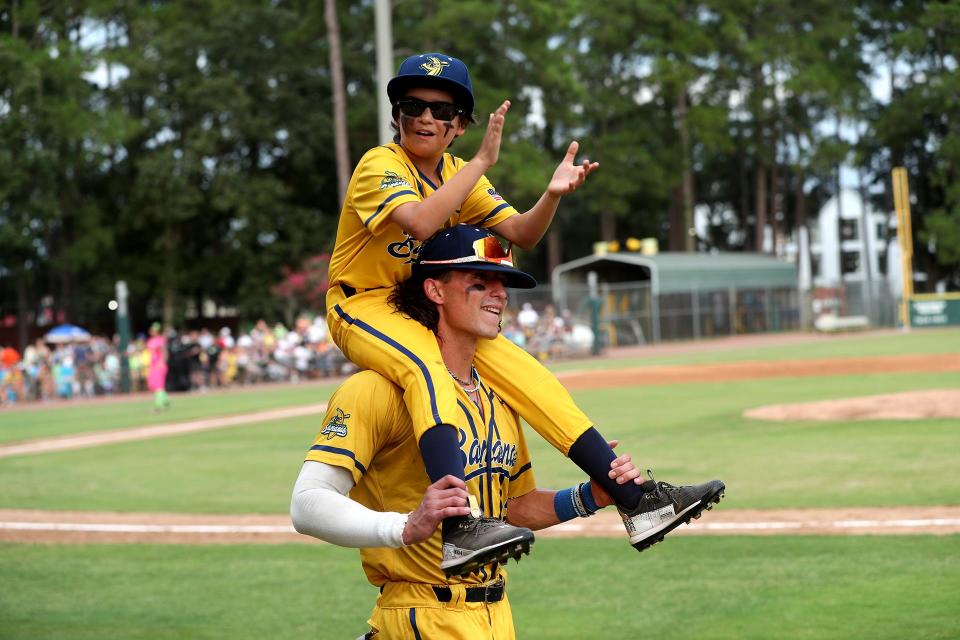 Mark "Swaggy" Lane helps pump up the crowd from Noah Bridges shoulders before the start of the Savannah Bananas home game against the Party Animals on Thursday, August 3, 2023 at Historic Grayson Stadium in Savannah, Georgia. Lane, who has a rare seizure disorder was granted his dream to be a Savannah Banana for a day through the Make-A-Wish Foundation.