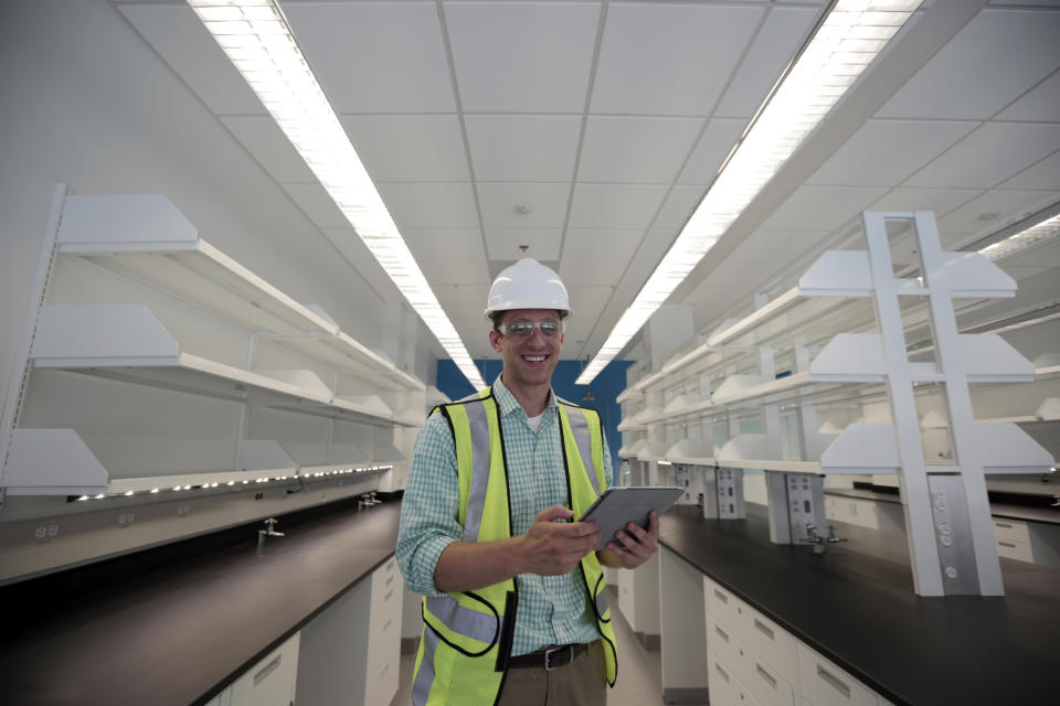 Drew Miller, poses for a photograph, at a building under construction, Wednesday, July 10, 2013 in Silver Spring, Md. Miller quit a steady government contract job to take a chance on a company that's using "smart technologies" to help big corporations cut lighting costs. (AP Photo/Alex Brandon)